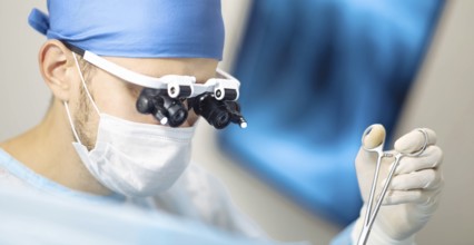 Medical professional using tools during a surgical procedure
