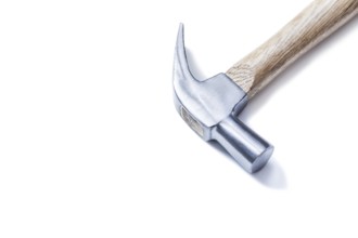 Claw hammer on yellow leather gloves isolated