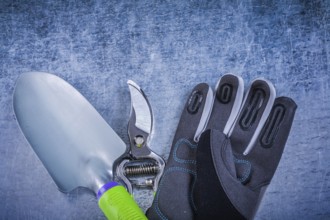 Set of hand trowel garden pruner protective gloves agriculture concept