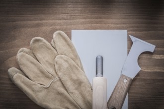 Putty knife plastering trowel and leather working gloves