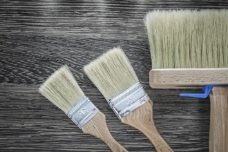 Paint brushes on wood board top view