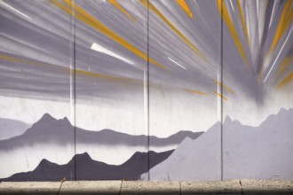 Frankfurt, Germany - August 11, 2018: The drawing of mountains and stylised sunbeams by an unknown