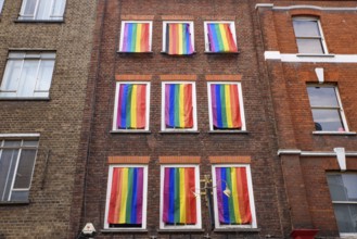 A wall with rainbow flags for LGBT community in Soho area in London, United Kingdom