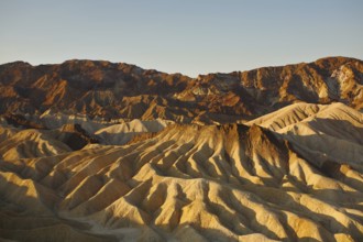 Precise mountain folds well-known Zabriskie-point in Death valley in the USA. A sunset