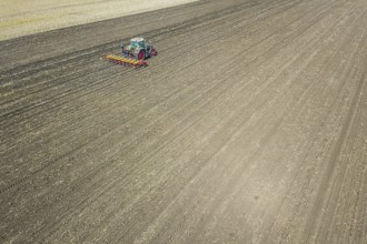 Farmer seeding crops at field. Seeding Aerial View