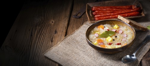 Rustic sauerkraut soup with bacon and sausage