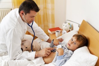 A doctor on a house call. Examining a sick child. Austria