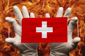 Doctor holding in white gloves protection medical face mask, respiratory bandage with Switzerland