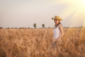 Woman in the wheat field, farmer with crop
