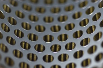 Detail of a tractor oil filter creates an industrial textured background