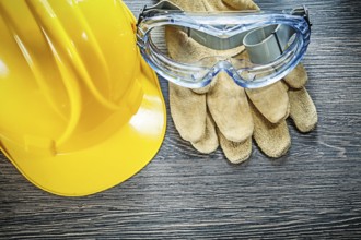 Safety goggles hard hat on wooden board