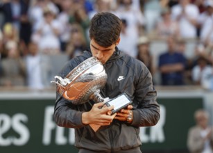 French Open 2024 winner Carlos Alcaraz kissing the trophy at Roland Garros, Paris, France.