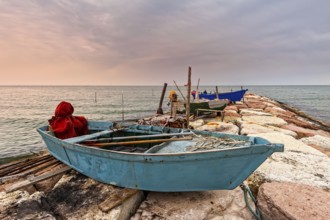 Fishing boat moored on cliff at sunset. Venice, Italy