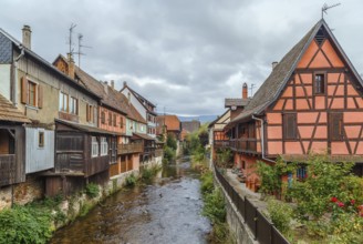 View of Weiss river with historical houses in Kaysersberg, Alsace, France