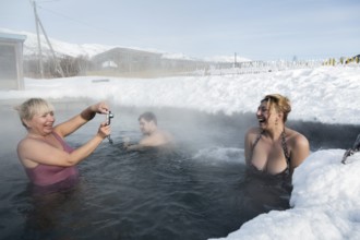 KAMCHATKA PENINSULA, RUSSIA, FEB 02, 2013: Two joyful women photographed while swimming in