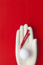 Detail of artifical hand with golf equipments - Flat Lay Photography