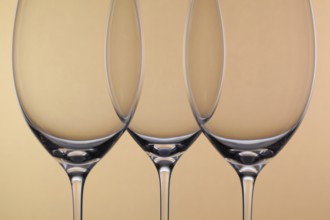 Three empty glasses of wine on a background
