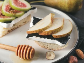 Toast with black camembert cheese and pears slices on plate. Healthy snack or breakfast idea and