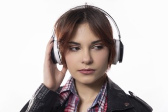 A stylish young woman enjoys her music with sleek headphones, showcasing a vibrant modern lifestyle