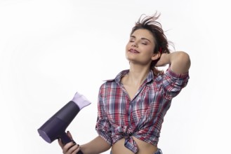 A confidently poised woman happily using a hair dryer, joyfully showcasing beautiful hair styling