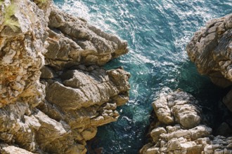 Rocks in the sea, waves hitting rocks.