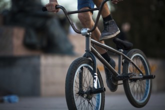 Young teenager bicyclist boy riding on beautiful orange bmx bicycle male hobby extreme sport male