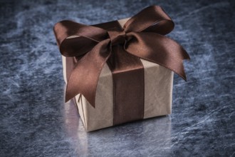 Gift box on scratched metallic background holidays concept