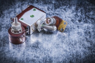 Electric toggle switch lamp-holder on metallic surface electricity concept
