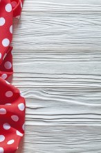 Red cotton polka-dot textile on wooden board