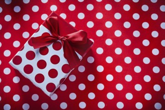 Wrapped box with present on polka-dot fabric celebrations concept