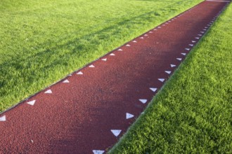 Running track with a red sysnthetic surface for a long jump competition