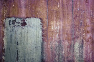 Rusty iron sheet with corrosion, selective focus, textured background