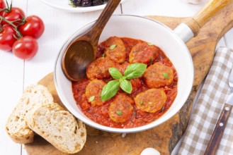 Baked mini meatballs in tomato sauce with basil