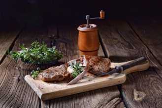 Grilled lamb chops on an old board