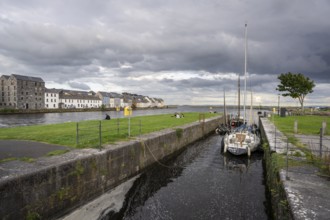 Boat anchored in Eglinton Canal Sea Lock, The Long Walk, Galway, Ireland, United Kingdom
