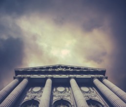 Retro Vintage Style Image Of A City Hall Or Courthouse Against A Stormy Sky