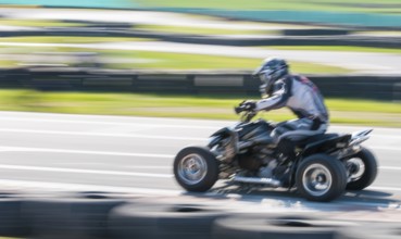 Unrecognised man is driving Go-kart with speed in the on a karting track