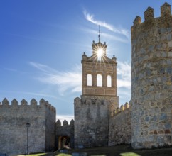 Avila, Spain, 8 April, 2024: view of the Avila city walls and the Puerta del Carmen with a sunstar