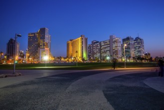 Amazing cityscape of Tel-Aviv, blurred people, luxury buildings- close to coastline ! Blue hour in