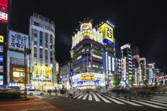 TOKYO, JAPAN, SEPTEMBER 16 2024: Neon signs illuminate with traffic in Tokyo's busy Shinjuku
