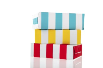 Stacked colorful striped presents isolated over white background