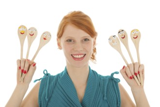 Woman cooking with funny wooden spoons