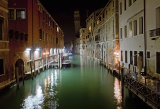 Venice channel at night with boats
