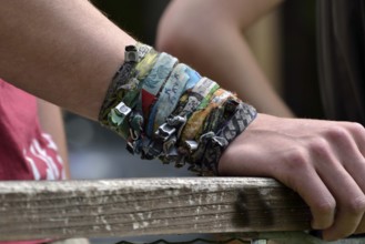A collection of bracelets on one arm