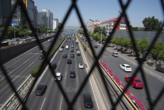 Beijing, China ? June 4 2019: Cars moving fast on a busy multi lane highway in city of Beijing in