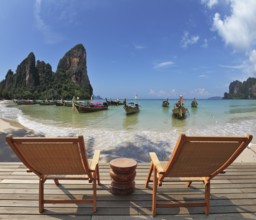 Cozy beach rest. Two wooden chaise lounges and small bedside table on a wooden scaffold. Native