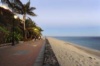 Promenade on the beach in the evening light, Morro Jable, Playa del Matorral, Jandia Peninsula,