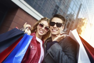 Portrait of a couple with shopping bags in the city.People, sale, love and happiness concept