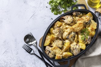 Baked mackerel with potatoes and cheese on a marble tabletop. Top view flat lay background. Copy