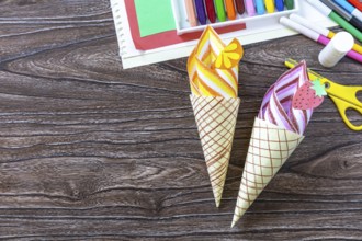 Paper Fan paper ice cream on a wooden table. Childrens art summer project, handmade, crafts for